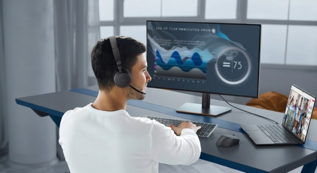 Business professional receiving a sales call while working at desk